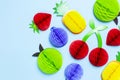 Flat lay bright tropical fruits of paper, strawberry, cherries, pineapple, apple, plum on blue background top view copy