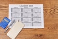 Flat lay calculator with pen and smartphone on wooden desk. Royalty Free Stock Photo