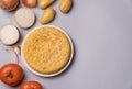 Flat lay of casserole potatoes and tomatoes on a gray background