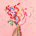 Flat lay of Celebration. Champagne bottle with colorful party streamers on pink background.Flat lay of Celebration. Champagne bott Royalty Free Stock Photo