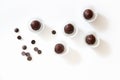 Flat lay with chocolate truffles sprinkled with freeze-dried strawberries in paper wrappers and scattered chocolate pills on white Royalty Free Stock Photo