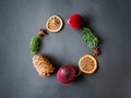 Flat lay Christmas circle frame composition - Spices, Christmas balls, dry orange slices, pine cone and fir branches on white Royalty Free Stock Photo