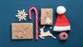 Flat lay Christmas holiday decorations set. Top view gift boxes wrapped kraft paper, candy cane, vintage wooden Xmas elements, New