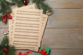 Flat lay with Christmas music sheets on wooden background, space for text Royalty Free Stock Photo