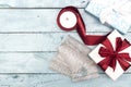 Flat lay with christmas presents, wrapping paper, white and red roll ribbon and crystal isolated on blue background.