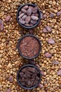 Flat lay  of clay bowl with Raw cocoa beans,  cocoa powder, chocolate on sacking  on coffee beans as background Royalty Free Stock Photo