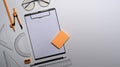 Clipboard, glasses and various stationery on white background. Royalty Free Stock Photo