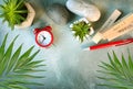 Flat lay with clock, flowers, pen, calendar and stones on a desktop. Royalty Free Stock Photo