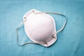 N95 protective face mask on solid blue background Royalty Free Stock Photo