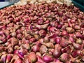 Flat Lay, Close-Up of Red Onions and Garlic in a Basket at a Supermarket Royalty Free Stock Photo