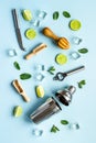 Flat lay of cocktail bar utensils and ingredietns - shaker, lime and ice