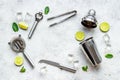 Flat lay of cocktail bar utensils and ingredietns - shaker, lime and ice