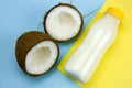 coconut and cocnut milk bottle on a yellow and blue background Royalty Free Stock Photo