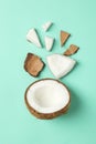 Flat lay with coconut on mint background