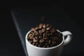 Flat lay of Coffee bean on white cup over a stone rock slate Royalty Free Stock Photo