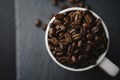 Flat lay of Coffee bean on white cup over a stone rock slate Royalty Free Stock Photo