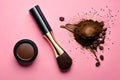 Flat lay of coffee beans with coffee powder cosmetics, and make up brush isolated on pink background