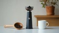 Flat lay of coffee beans, a grinder, and a white ceramic cup on a Royalty Free Stock Photo
