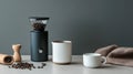 Flat lay of coffee beans, a grinder, and a white ceramic cup on a Royalty Free Stock Photo