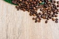 Flat lay, Coffee beans scattered on a light wooden table, top view, closeup grains, place to insert text, copy space