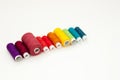 Flat lay with colorful cotton thread spools, embroidery yarn, rainbow bobbins, mock up, top view. Layout mockup on blank white Royalty Free Stock Photo