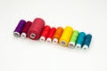 Flat lay with colorful cotton thread spools, embroidery yarn, rainbow bobbins, mock up, top view. Layout mockup on blank white Royalty Free Stock Photo