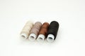 Flat lay colorful cotton thread spools, embroidery yarn, white, brown, black, bobbins, mock up, top view. Layout mockup, blank Royalty Free Stock Photo