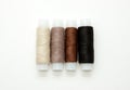 Flat lay colorful cotton thread spools, embroidery yarn, white, brown, black, bobbins, mock up, top view. Layout mockup, blank Royalty Free Stock Photo