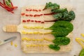 Flat lay of colorful cut stems of Chard vegetables on a wooden chopping board Royalty Free Stock Photo