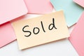 Flat lay of colorful notes with text Sold on yellow note Royalty Free Stock Photo