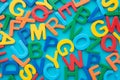 Flat lay of colorful word alphabets letter on blue background. Language education, kids development