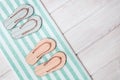 Flat lay of composed miniature of beach lounge area with summer shoes - two pair flip-flops, terry towel Royalty Free Stock Photo