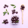 Composition with acai berries on violet background, flat lay Royalty Free Stock Photo