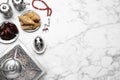 Flat lay composition with Arabic lantern and snacks on white marble table . Space for text Royalty Free Stock Photo