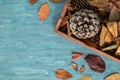 Flat lay composition for autumn holidays greeting cards. Pine cones, oak branches, acorns, leaves, chestnuts in a wooden box on th Royalty Free Stock Photo