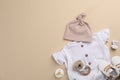Flat lay composition with baby clothes and accessories beige background, space for text Royalty Free Stock Photo