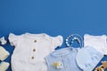 Flat lay composition with baby clothes and accessories on blue, space for text Royalty Free Stock Photo