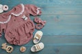 Flat lay composition with baby clothes and accessories on light blue wooden table. Space for text Royalty Free Stock Photo