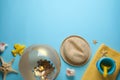 Flat lay composition with ball and beach objects on light blue background, space for text Royalty Free Stock Photo
