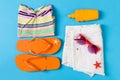 Flat lay composition with Beach accessories on blue color background. Summer holiday background. Vacation and travel items top Royalty Free Stock Photo