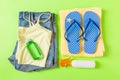 Flat lay composition with Beach accessories on green color background. Summer holiday background. Vacation and travel items top Royalty Free Stock Photo