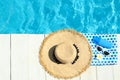 Flat lay composition with beach accessories on wooden deck near swimming pool Royalty Free Stock Photo