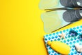 Flat lay composition beach accessories on yellow background, space for text