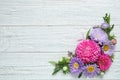 Flat lay composition with beautiful aster flowers on wooden table. Space for text Royalty Free Stock Photo