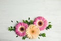 Flat lay composition with beautiful bright gerbera flowers on wooden background, top view. Royalty Free Stock Photo