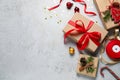 Flat lay composition with beautiful gift boxes and Christmas decorations on light grey table. Space for text Royalty Free Stock Photo