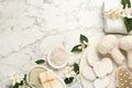 Flat lay composition with beautiful jasmine flowers and spa stones on white marble table, space for text Royalty Free Stock Photo