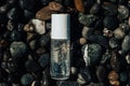 Flat lay composition of a beauty product transparent bottle on wet beach stones . Fresh ocean scented product mock up Royalty Free Stock Photo
