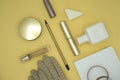 Flat lay composition of beauty products and handbag for women. Pastel and gold colors on gold background.