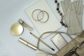 Flat lay composition of beauty products and handbag for women. Pastel and gold colors on white background.